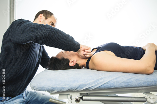 Physiotherapist working by massaging a patient in the neck. Concept of physiotherapy