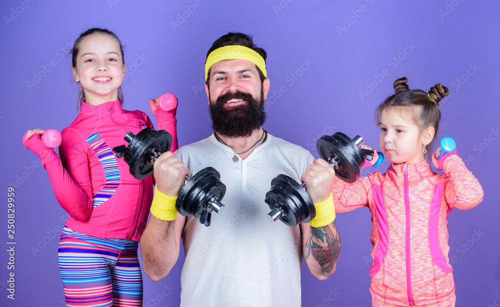 Follow father. Girls cute kids exercising with dumbbells with dad. Motivation and sport example concept. Children repeat exercise after dad. Sport exercise for kids. Healthy upbringing. Sporty family Follow father. Girls cute kids exercising with dumbbells with dad. Motivation and sport example concept. Children repeat exercise after dad. Sport exercise for kids. Healthy upbringing. Sporty family