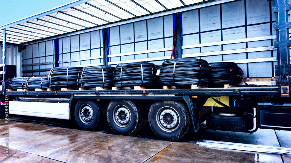There is a loading to the truck trailer . Concept of wholesale . fastening of freight in the trailer . distribution warehouse .