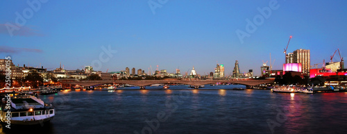 Night view of London Skyline, illuminated Waterloo Bridge and modern skyscrapers present.