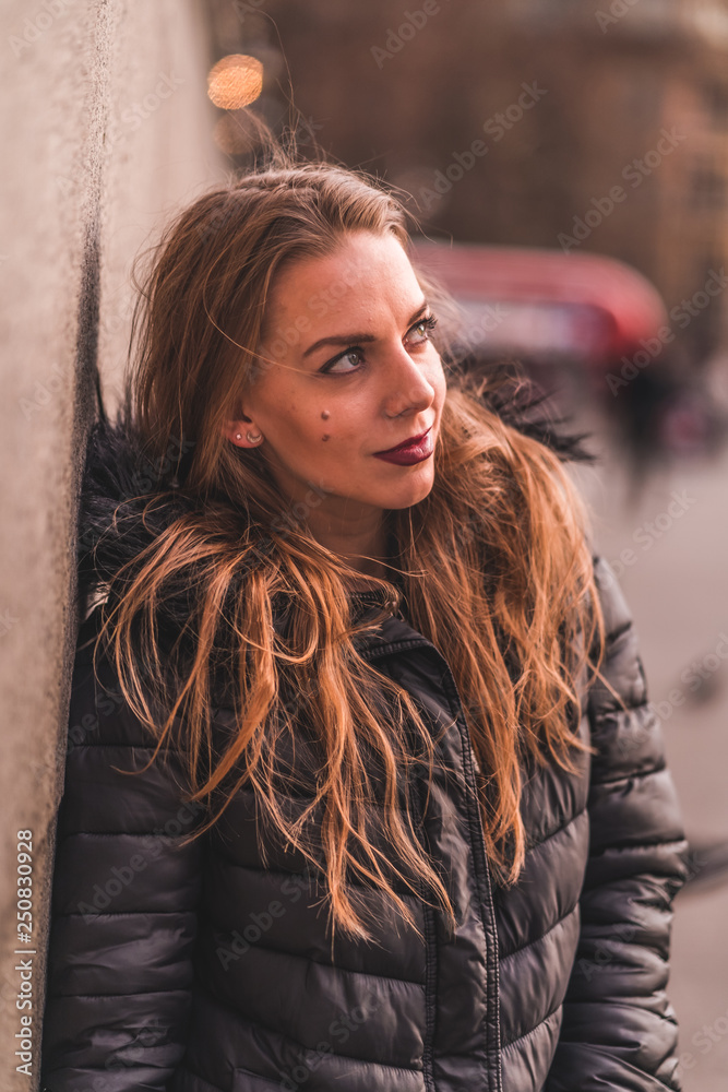 Fototapeta premium fashionable portrait of young beautiful woman in a European city on a sunny winter day