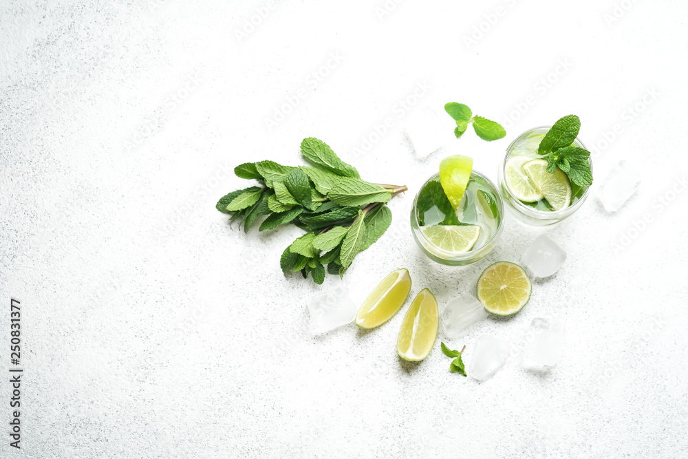 Mojito cocktail with mint and lime on a light background Copy space top view. - obrazy, fototapety, plakaty 