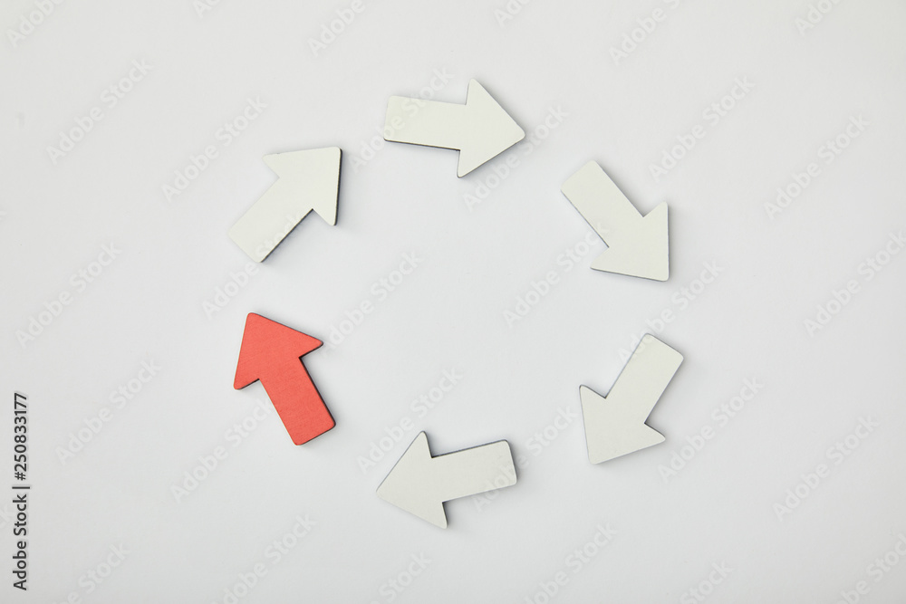 top view of white arrows and red pointer in circle on grey background top view of white arrows and red pointer in circle on grey background