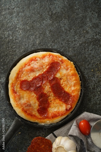 Pi day pepperoni Pizza overhead view