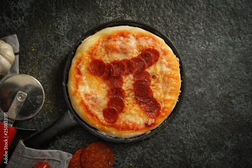 Pi day pepperoni Pizza overhead view
