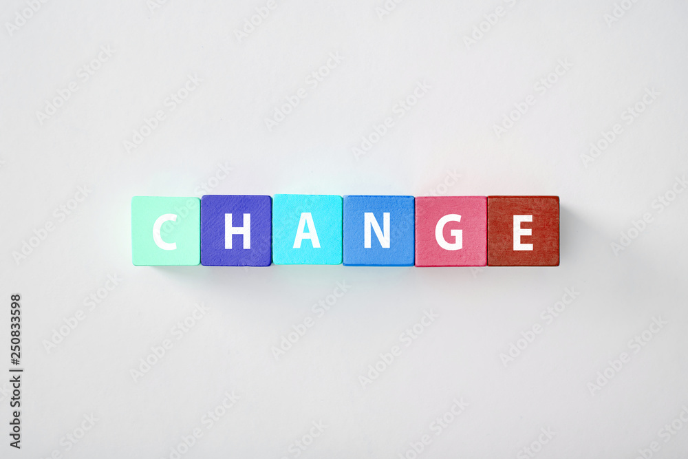 top view of change lettering made of multicolored cubes on grey background top view of change lettering made of multicolored cubes on grey background
