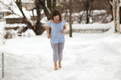 kid pounded with snow and playing barefoot in snow