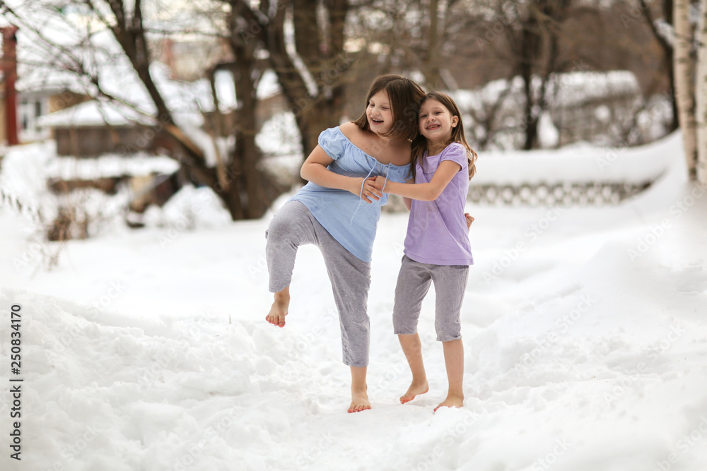 Cheerful children play barefoot in snow. hardening Cheerful children play barefoot in snow. hardening
