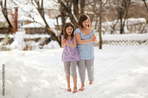 Happy girls children in snow barefoot, health care