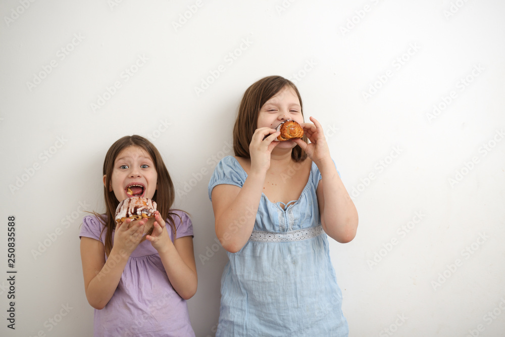 Funny hungry girls eat sweet buns on light Funny hungry girls eat sweet buns on light