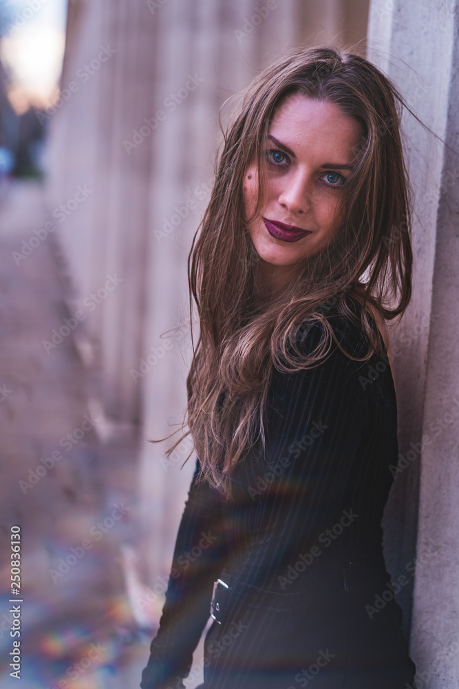Naklejka premium fashionable portrait of young beautiful woman in a European city on a sunny winter day