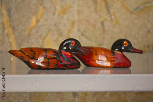 Two wooden ducks, background, close-up