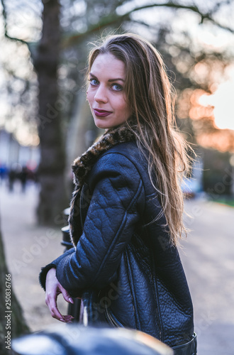 fashionable portrait of young beautiful woman in a European city on a sunny winter day