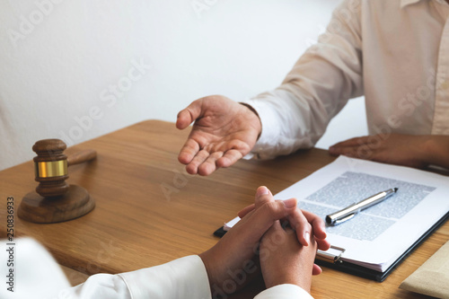 Lawyer present client with contract papers on the table in office. consultant lawyer, attorney, court judge, concept.