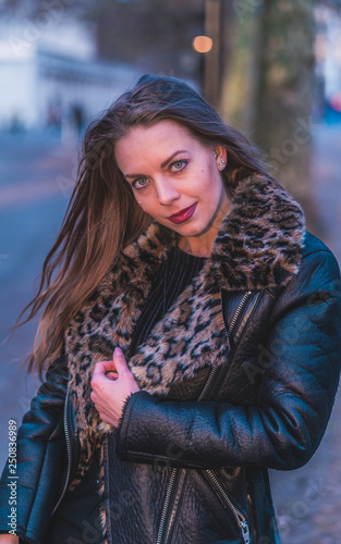 fashionable portrait of young beautiful woman in a European city on a sunny winter day