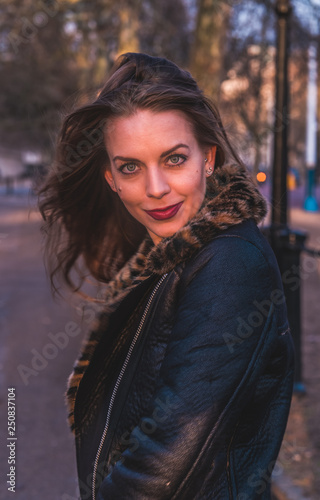 fashionable portrait of young beautiful woman in a European city on a sunny winter day