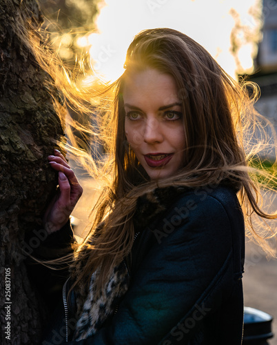 fashionable portrait of young beautiful woman in a European city on a sunny winter day