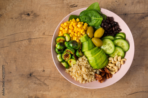 budha bowl with brussel cabbage, corn, quinoa, cucumbers,nuts, avocado and spinach