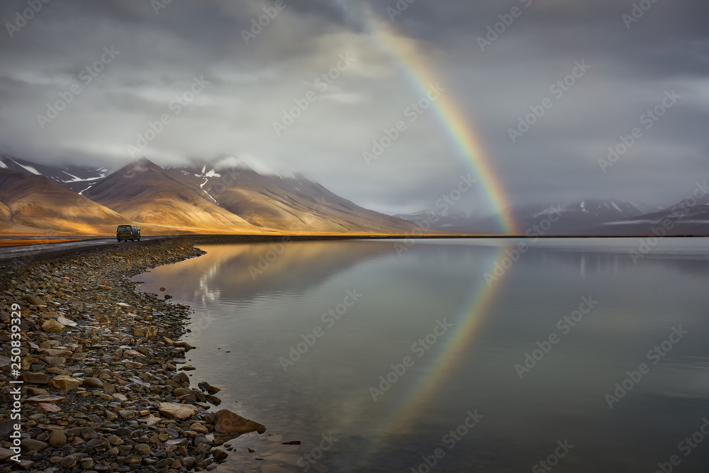 Arctic landscape with rainbow after rain in Svalbard during autumn. Norway