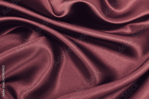 Smooth elegant pink silk or satin luxury cloth texture as abstract background. Luxurious valentines day background design