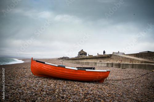 Dark skies over Chesil famous for its pebble beach in Weymouth, a coastal town in the county of Dorset, England, UK. photo