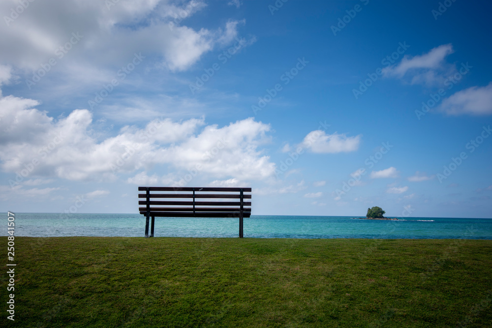 Wooden bench in front of the sea