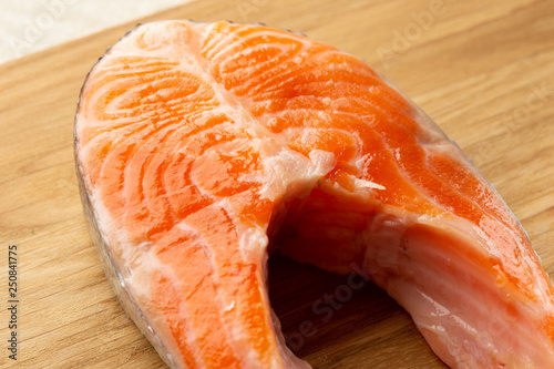 Uncooked red fish fillet on wooden surface