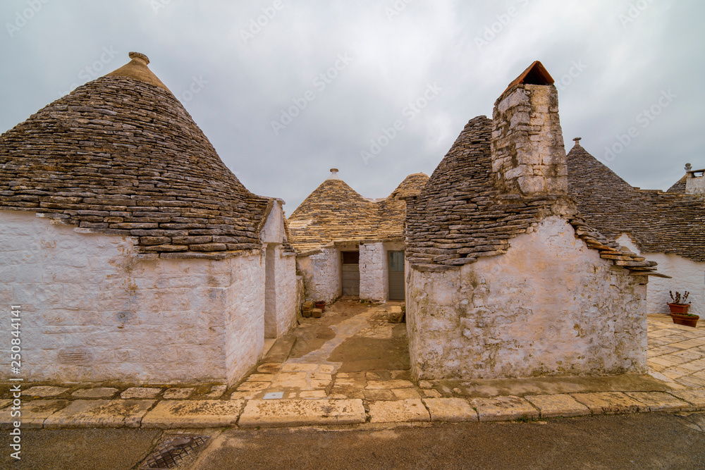 ALBEROBELLO, APULIA, ITALY - FEBRUARY 03 - Beautiful view of the traditional trulli houses with their conical roof on february 03, 2019 
