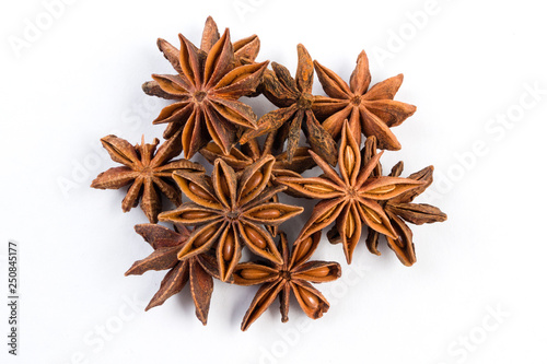 heap of anise stars isolated on white background. top view