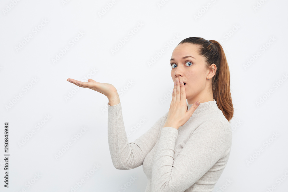 young woman holding copyspace hiding something young woman holding copyspace hiding something