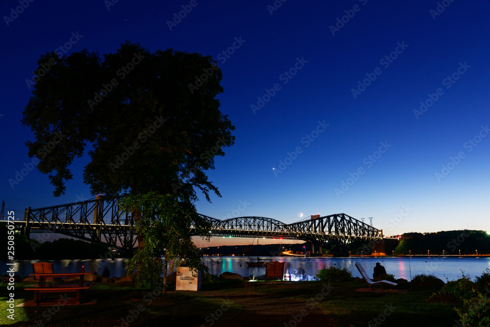 The Pont du Quebec and the St Lawrence River at dusk as seen from Parc de la Marina-de-la-Chaudière, St-Romuald