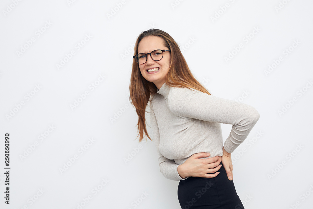 young woman pain in the back and feeling uncomfortable young woman pain in the back and feeling uncomfortable