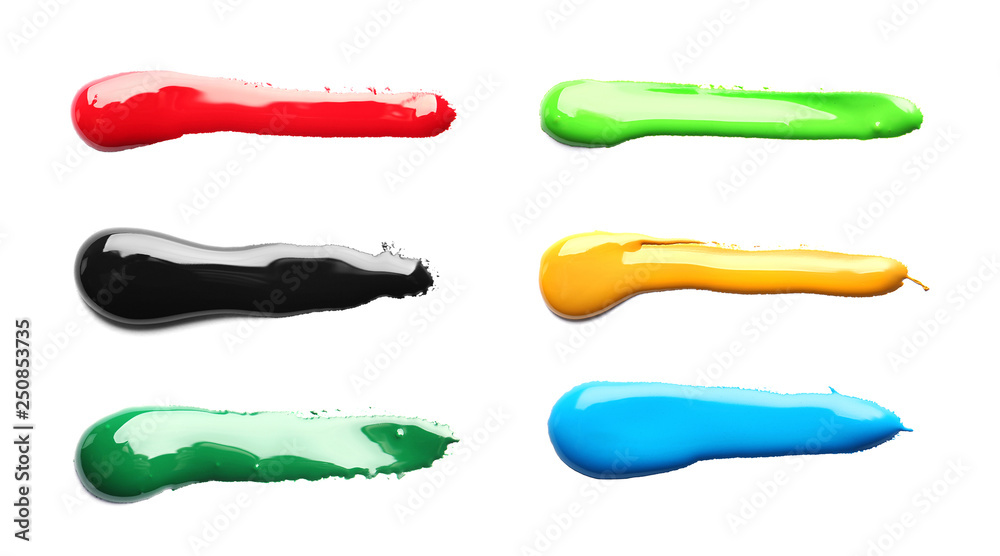 Set with abstract brushstrokes of different bright paints on white background, top view