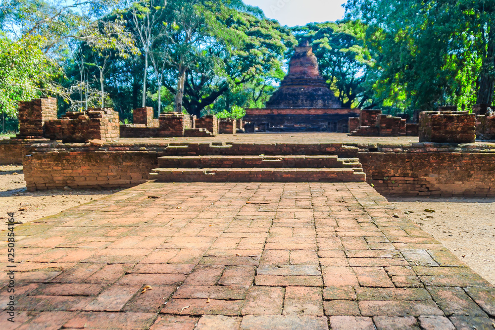 Lanka style ruins pagoda of Wat Mahathat temple in Muang Kao Historical Park, the ancient city of Phichit, Thailand. This tourist attraction is public historic site and free admission.