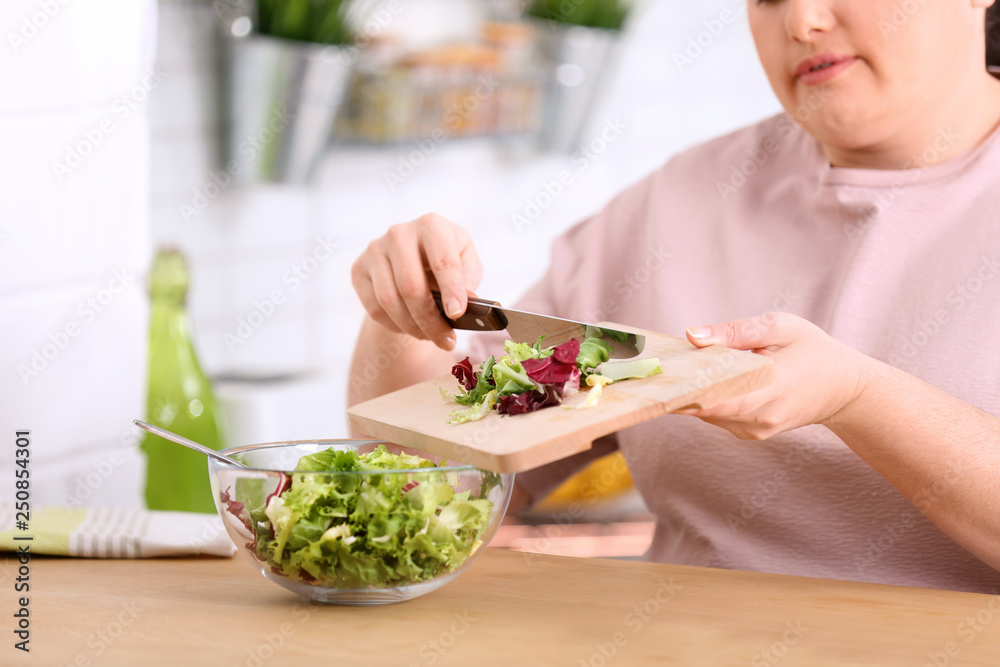 Overweight woman preparing salad in kitchen. Healthy diet Overweight woman preparing salad in kitchen. Healthy diet