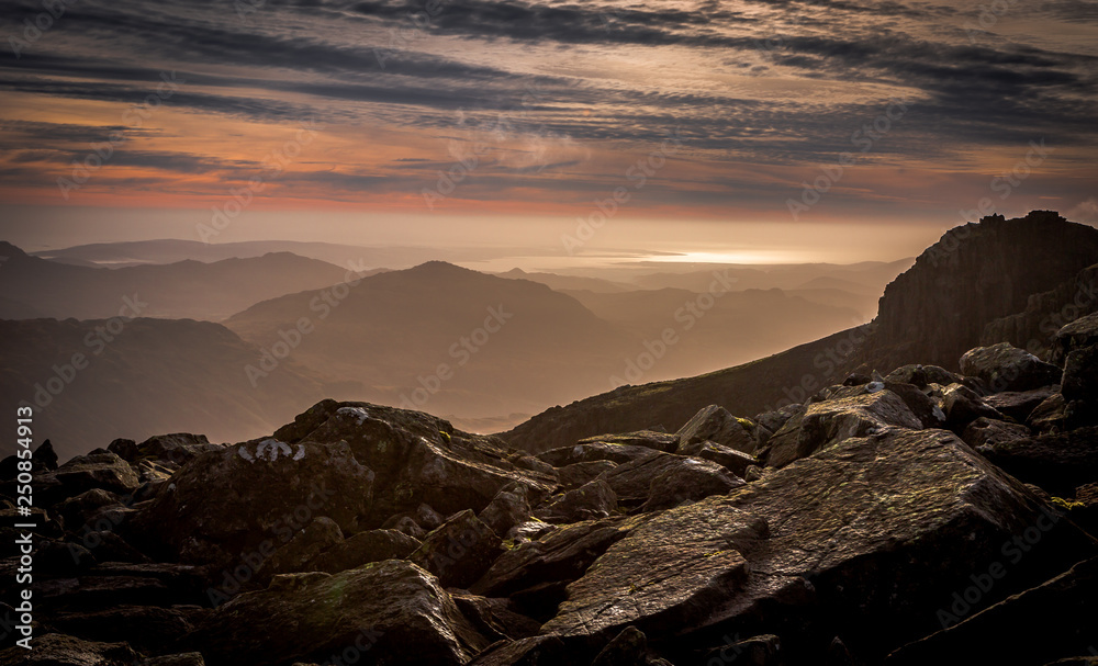 The view south from Scafell Pike - England's highest peak at 3,209ft, looking across the peaks of the Lake District, Eskdale & the NW coastline in the distance.