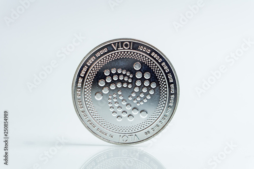 IOTA. Crypto currency silver coin, Macro shot of Iota coin isolated on white background, cut out Blockchain technology, photo