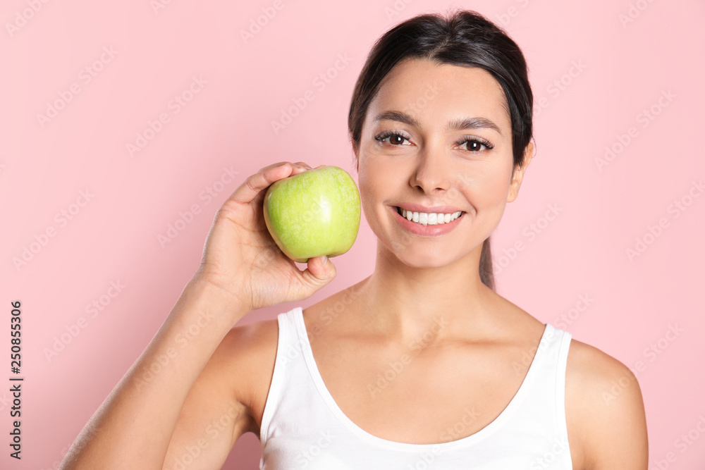 Young woman with healthy teeth and apple on color background Young woman with healthy teeth and apple on color background