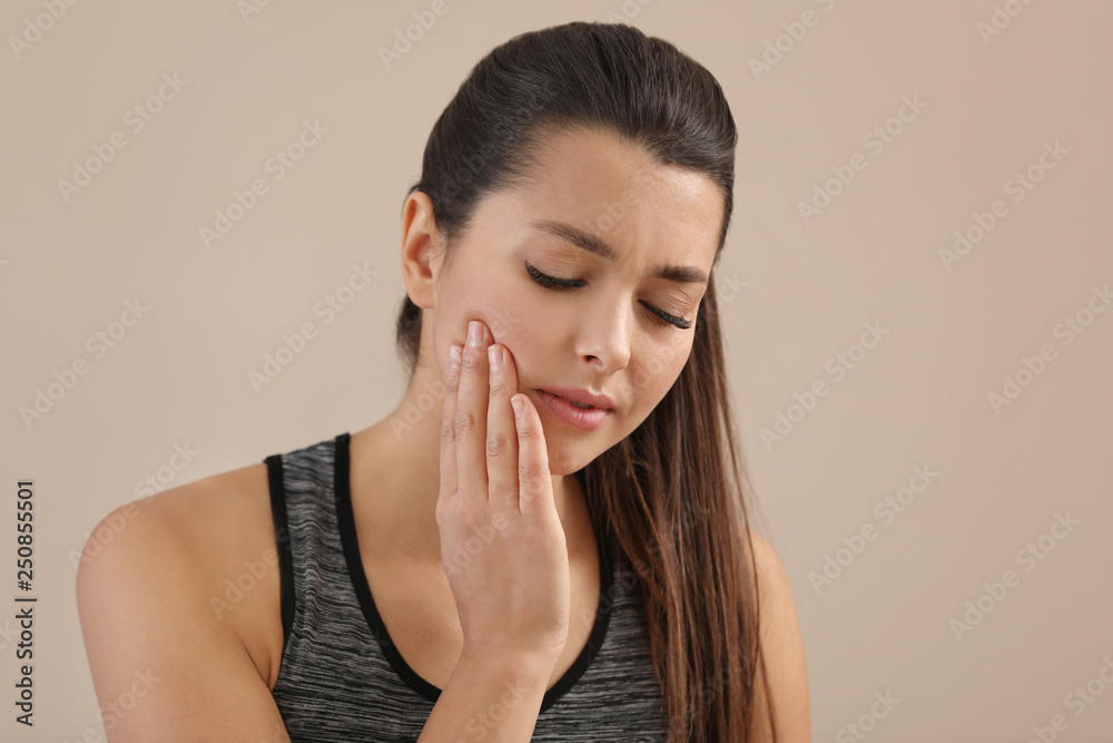 Young woman with sensitive teeth on color background. Space for text Young woman with sensitive teeth on color background. Space for text