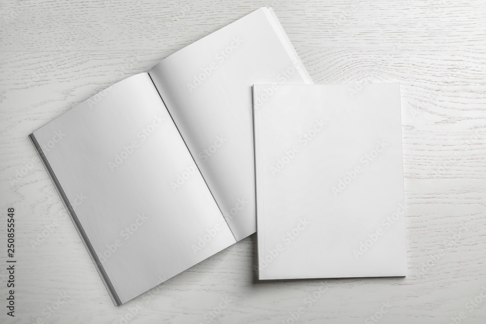 Open and closed blank brochures on wooden background, top view. Mock up for design Open and closed blank brochures on wooden background, top view. Mock up for design