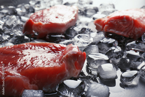 Quadro em tela Raw meat and ice cubes on table