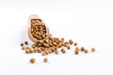 coriander seeds in wooden scoop isolated on white background.