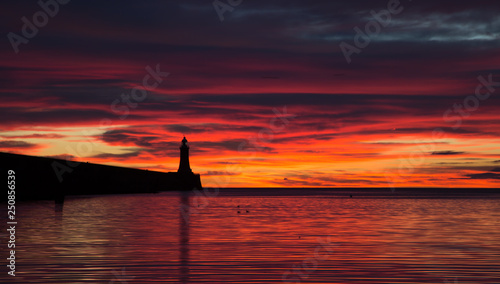 A beautiful sunrise over the North Pier Lighthouse at the mouth of the River Tyne in Tynemouth, England