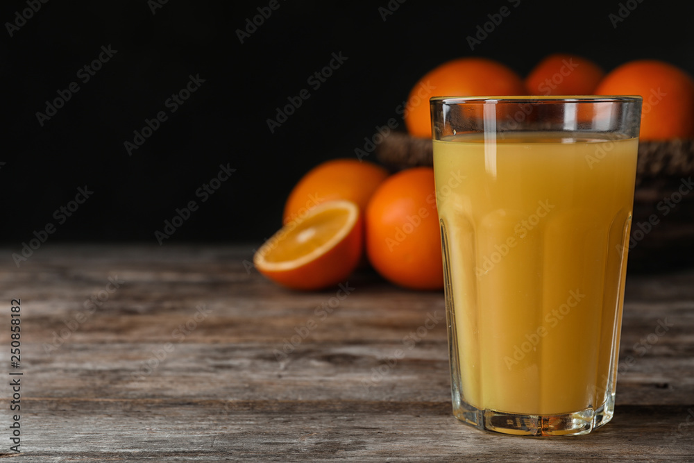 Glass of orange juice on wooden table. Space for text Glass of orange juice on wooden table. Space for text
