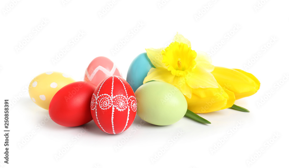 Colorful painted Easter eggs and spring flowers on white background Colorful painted Easter eggs and spring flowers on white background