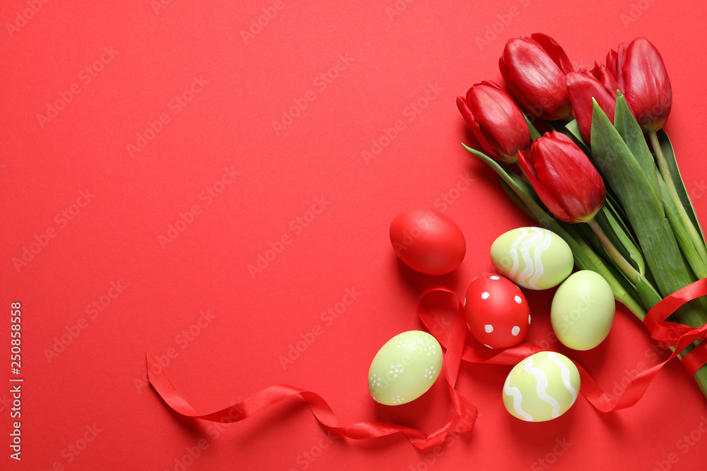 Flat lay composition of painted Easter eggs and spring flowers on color background, space for text Flat lay composition of painted Easter eggs and spring flowers on color background, space for text