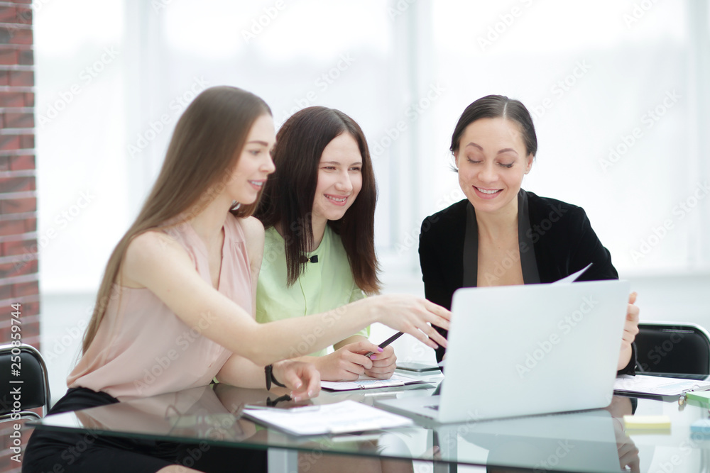 three business women discussing work issues in the office three business women discussing work issues in the office