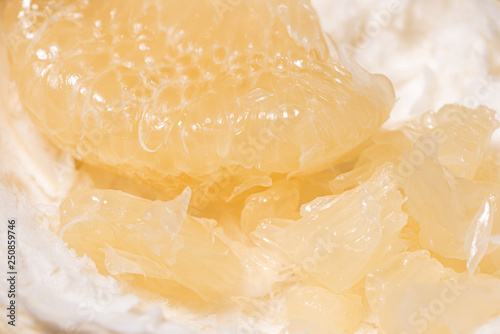 peeled citrus fruit Pomelo on a wooden background photo