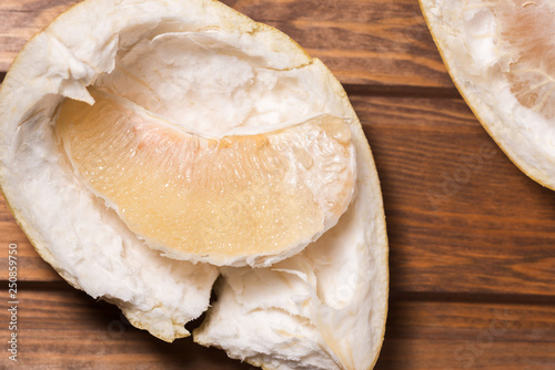 peeled citrus fruit Pomelo on a wooden background photo
