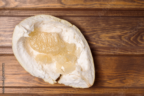 peeled citrus fruit Pomelo on a wooden background photo